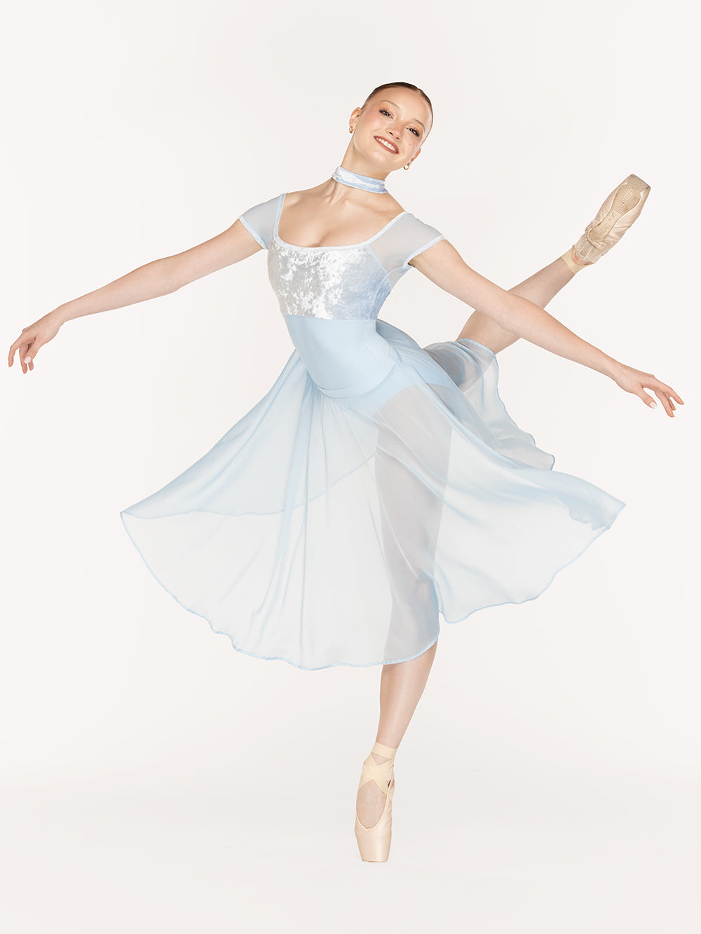 Eleve Dancewear Jane Leotard in True Blue color, front view of dancer on pique attitude derriere croise