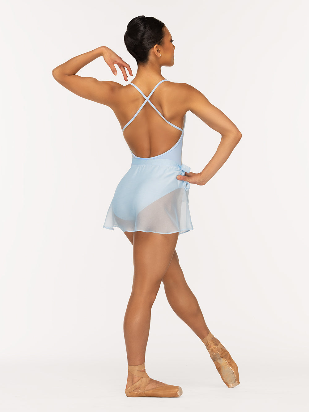 Eleve Dancewear Rachel Leotard and Chiffon Mini Tie Skirt Kids in True Blue color, back view of dancer on tendu devant