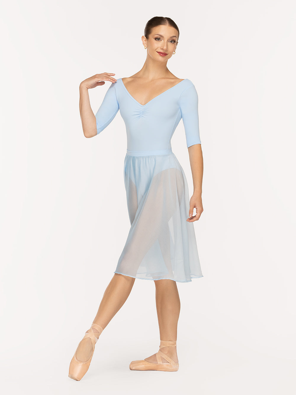 Eleve Dancewear Chiffon Rehearsal Skirt in True Blue color, front view of dancer on tendu devant