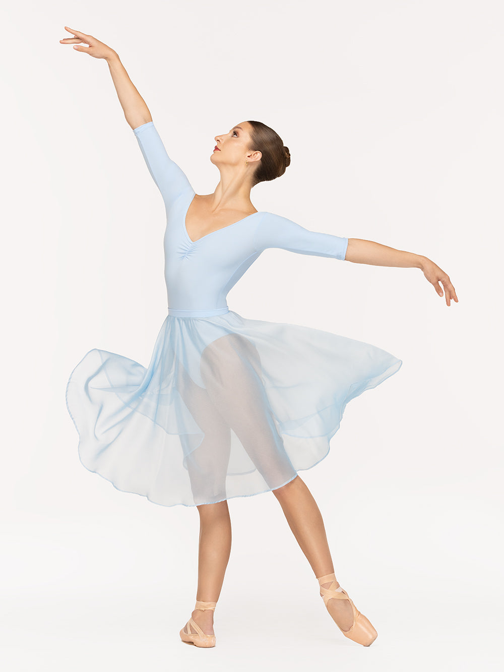 Eleve Dancewear Chiffon Rehearsal Skirt Kids in True Blue color, profile view of dancer on tendu derriere
