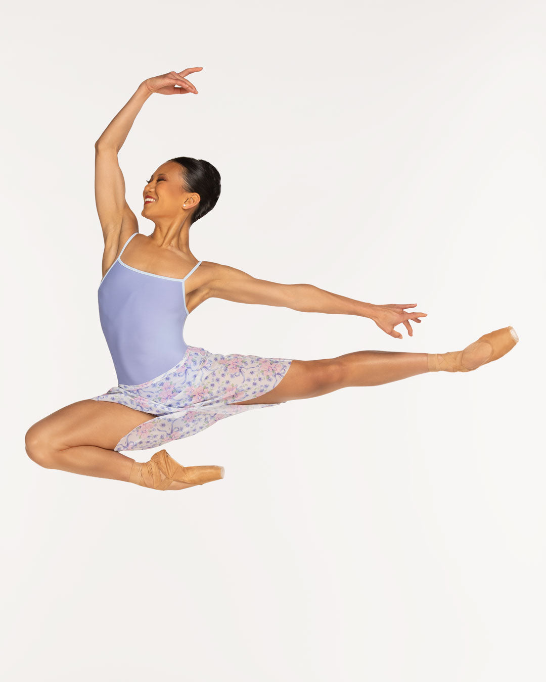 Eleve Dancewear Candy Leotard in Twilight color, front view of dancer in high passe jump