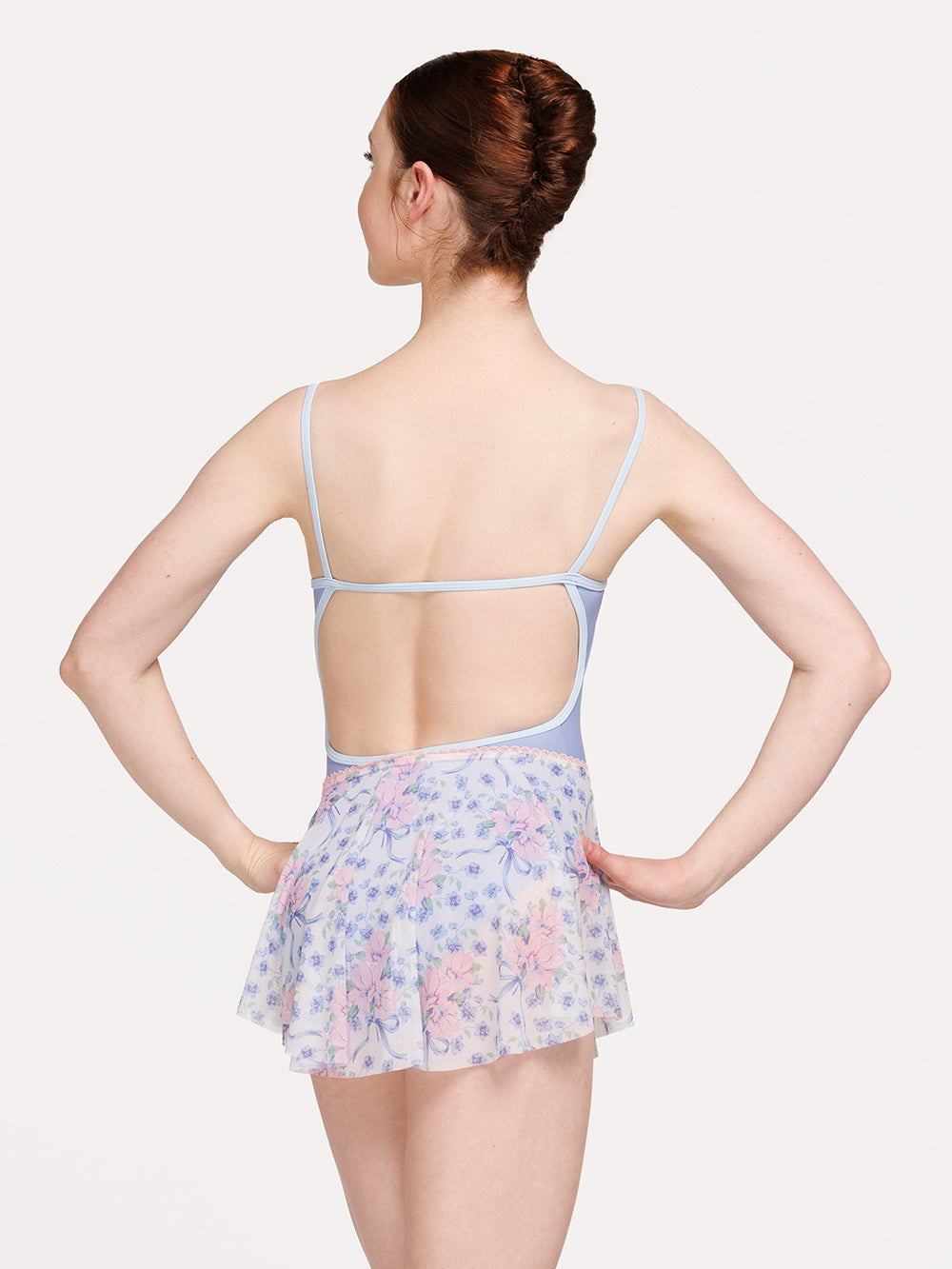 Eleve Dancewear Circle Mini Skirt in Flowers & Bows print, back view of dancer posing