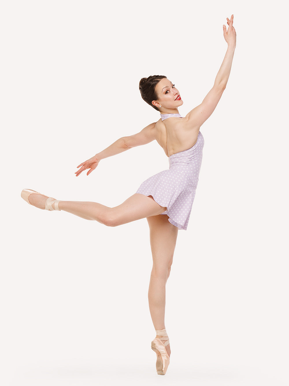 Eleve Dancwear Flare Skirt in Whisper Polka Dot print color, profile view of dancer on pique attitude efface epaulement