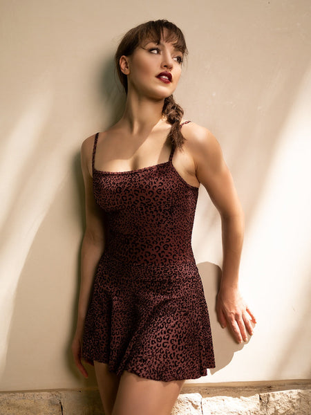 Model wearing a cheetah print leotard and matching skirt