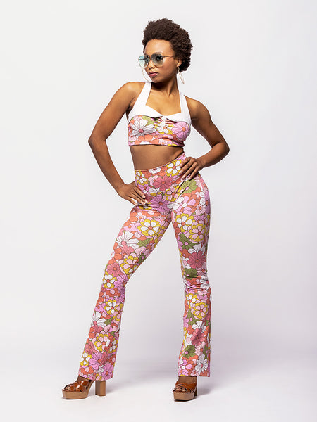 Model in bell bottom tights with matching crop top in floral pattern print 