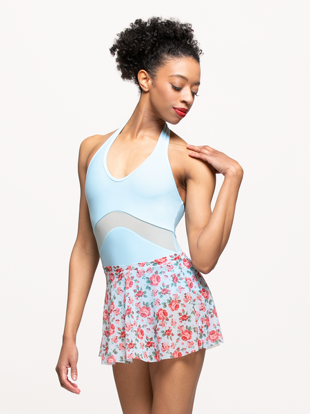 model in true blue mesh skirt with red rose patterns