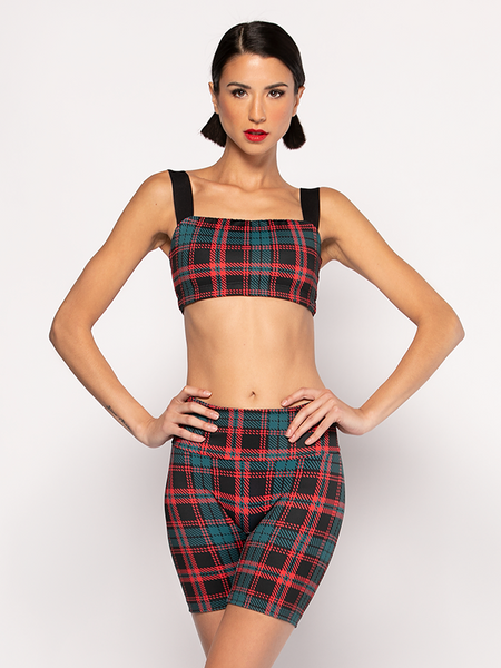 Model in Christmas plaid crop top and marching bike shorts holiday themed athletic activewear set