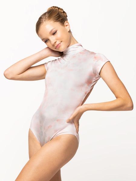 Model is wearing shiny rose watercolor print leotard with high neck and cap sleeves