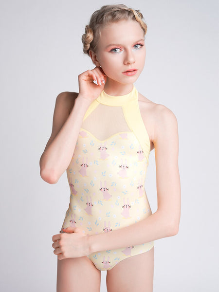 Model wearing a yellow Easter pattern leotard with mesh detail