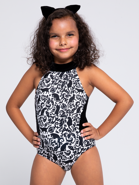 model in Leotard with black vintage cat pattern and black flanks and hands on hips