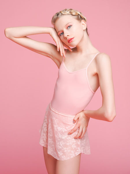 Model wearing a pink leotard with a matching floral pink mesh skirt