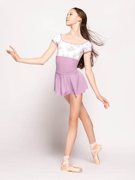 Model wearing a purple and floral print leotard with a matching purple skirt