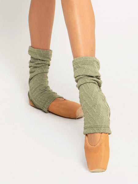Model is in sage ankle warmers