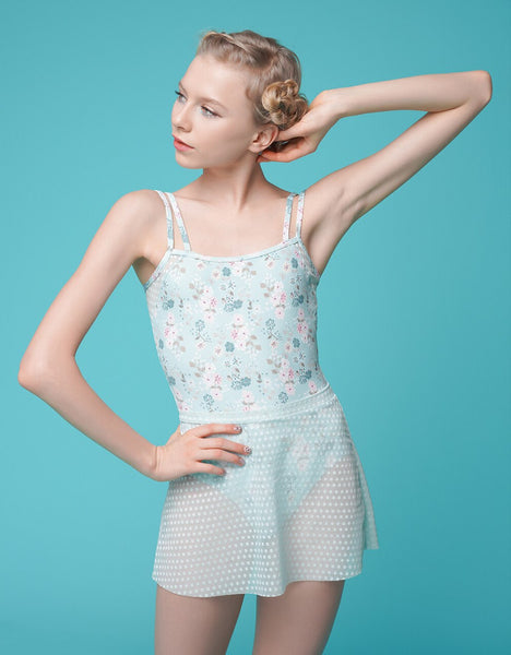 Model wearing light blue floral print leotard with powder blue mesh polka dot skirt