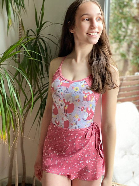 Model wearing a fox print leotard with a matching pink floral wrap skirt