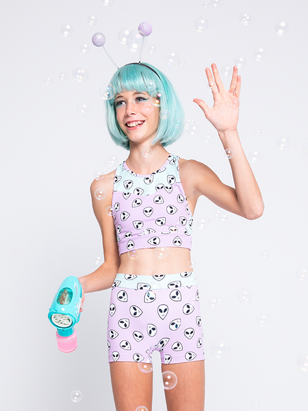 Front view of model in Orchid pink and mint green alien face print crop-top and shorts