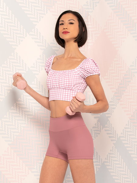 Model in quartz gingham crop top with puff sleeves and dark quartz shorts