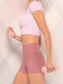 Model in quartz gingham crop top with puff sleeves and dark quartz shorts