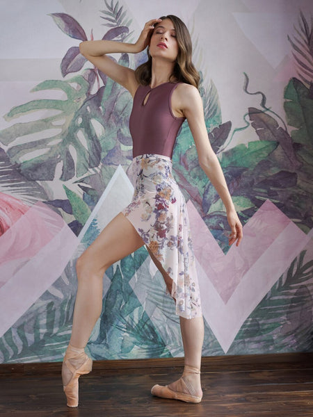 Model wearing a shiny dark mauve leotard with a matching white floral pattern mesh skirt