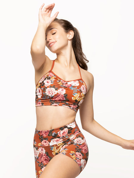 Model is wearing crop top in picante orange floral print with cami straps and pinch detail and matching bike shorts
