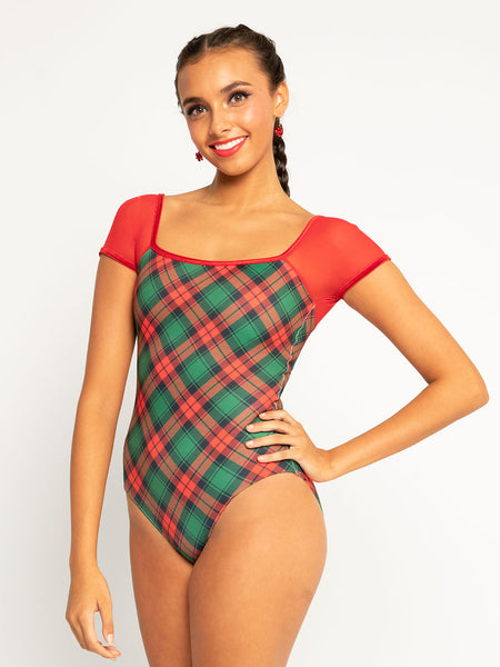 Model in plaid leotard with red mesh shoulders 