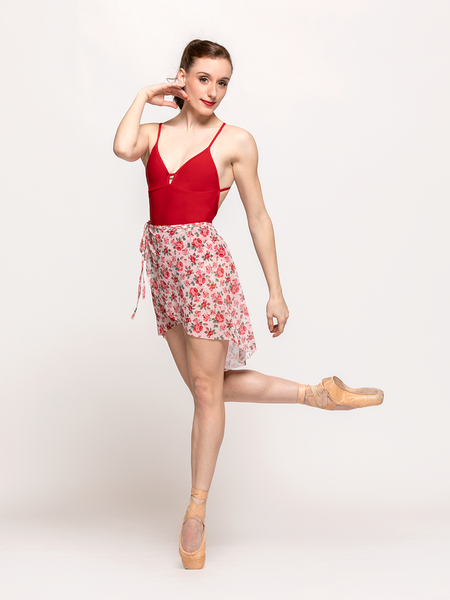 model in mesh skirt with pink base and red flowers 