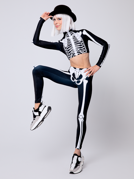 Model in X-Ray skeletons Crop-top leg raised in standing pose 